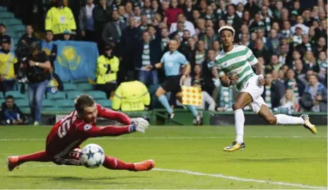  ?? JEFF HOLMES/THE ASSOCIATED PRESS ?? Celtic’s Scott Sinclair scores his side’s second goal in their Champions League playoff game against Astana at Celtic Park in Glasgow on Wednesday.