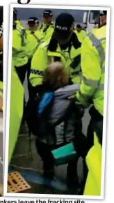  ??  ?? Arms of the law: Police remove the ladies to let tankers nkers leave the fracking site