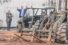  ?? John Spink/Associated Press ?? Atlanta Police Foundation CEO Dave Wilkinson, center, examines property damaged during a protest Monday at the Atlanta Public Safety Training Center in DeKalb County, Ga.