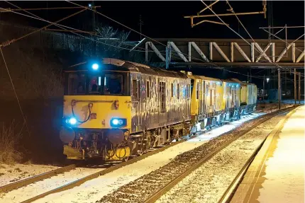  ??  ?? Caledonian Sleeper Class 73 No. 73967 exits the civil engineers sidings at Carstairs on February 10, with the 6X69/22.46 to Westerton (East Dunbartons­hire) conveying Schweerbau rail milling machine No. DR79601. The ‘ED’ replaced No. 66773 on this working as the ‘66’ was taken off to work the 1S25 ‘Highlander’ sleeper from Edinburgh to Inverness. Jack Prentice