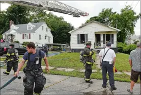  ?? DANA JENSEN/THE DAY ?? Firefighte­rs work at the scene of a house fire Friday on Ashcraft Road in New London.