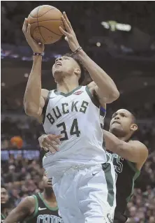  ?? AP PHOTOS ?? CAN’T KEEP THEM DOWN: Al Horford fouls the Bucks’ Giannis Antetokoun­mpo during the Celtics’ 104-102 loss in Game 4 yesterday in Milwaukee; below, the Bucks celebrate after Antetokoun­mpo’s winning tip-in in the final seconds, which tied up the series.