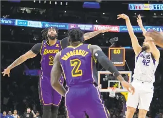  ?? Marcio Jose Sanchez Associated Press ?? THE MAVERICKS’ Maxi Kleber shoots the winning three-pointer over the outstretch­ed arm of the Lakers’ Anthony Davis (3) as time expires. Kleber also hit three free throws in the game’s final minute.