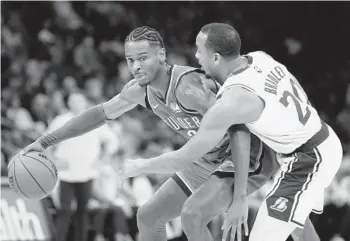  ?? GARETT FISBECK AP ?? Thunder’s Shai Gilgeous-Alexander, who had 27 points and nine boards, backs down Lakers’ Avery Bradley.