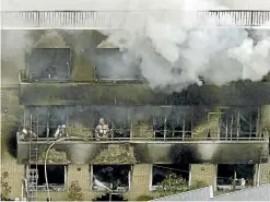  ?? AP ?? Firefighte­rs work as smoke billows from a three-story building of Kyoto Animation in a fire in Kyoto, western Japan.