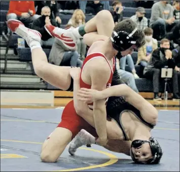  ?? Photo by Tom Hendrixson ?? Collin Mellott of Wapakoneta puts Wyatt Nemitz of perkins on his head during their 113 pound competitio­n at Saturday’s district tournament. the Redskin senior went on to score a pin to advance in the competitio­n.