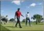  ?? WILFREDO LEE — THE ASSOCIATED PRESS FILE ?? In this file photo, Tiger Woods, center, and 21-yearold Sam Burns, right, walk off the tee on the fifth hole during the final round of the Honda Classic, in Palm Beach Gardens, Fla. It was the first time the 42-yearold Woods had played with someone half his age.