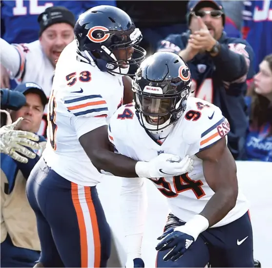  ?? ADRIAN KRAUS/AP ?? Bears outside linebacker Leonard Floyd (94) celebrates with Roquan Smith after returning an intercepti­on 19 yards for a touchdown in the second quarter.