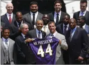  ?? CHARLES DHARAPAK — THE ASSOCIATED PRESS ?? President Barack Obama holds a Baltimore Ravens football jersey with head coach John Harbaugh, second from right, during a 2013 ceremony outside of the White House.