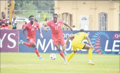  ?? ?? Simonsen Jeppe Friborg (no.13) of Haiti attempts to dribble Leo Lovell of Guyana at the National Track and Field Centre, Leonora during their Nations League clash yesterday.