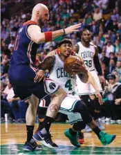  ?? THE ASSOCIATED PRESS ?? Boston Celtics guard Isaiah Thomas (4) drives to the basket against Washington Wizards center Marcin Gortat, left, during their second-round NBA playoff series game in Boston on Tuesday. Thomas scored 53 points.