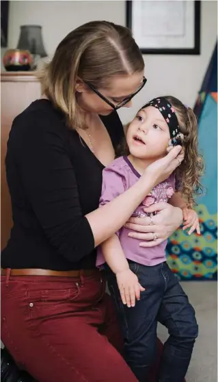  ?? Whitten Sabbatini / New York Times ?? Three-year-old Evelyn Steadman, who was born with cytomegalo­virus and has microcepha­ly and deafness, with her mother, Erica, in Crete, Ill.