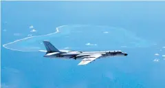  ??  ?? A Chinese H-6K bomber patrols the islands and reefs in the South China Sea, In this undated photo released by Xinhua News Agency.