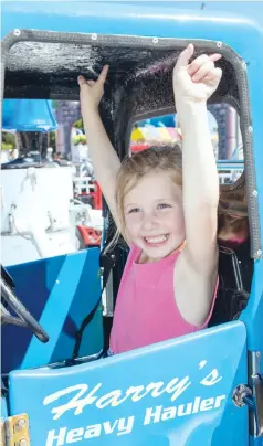  ??  ?? Inica Butterwort­h raised her arms in the air as she prepared herself for one of the carnival rides at last year’s show.