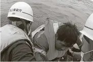  ?? Japan Coast Guard / AFP via Getty Images ?? This image grab shows a man being rescued from a life raft by the Japan Coast Guard after a ship carrying 43 crew members and almost 6,000 cows sank.