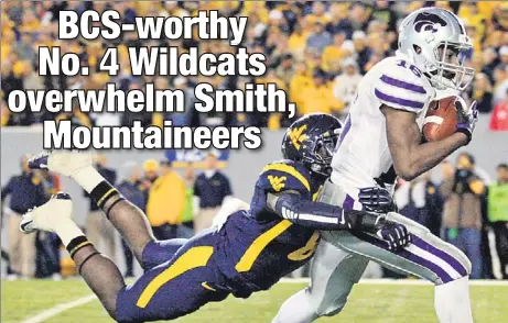  ?? AP ?? GET BACK HERE! Kansas State’s Tyler Lockett drags West Virginia’s Karl Joseph along on a pass reception during the second quarter of the Wildcats’ 55-14 victory last night in Morgantown, W.Va.