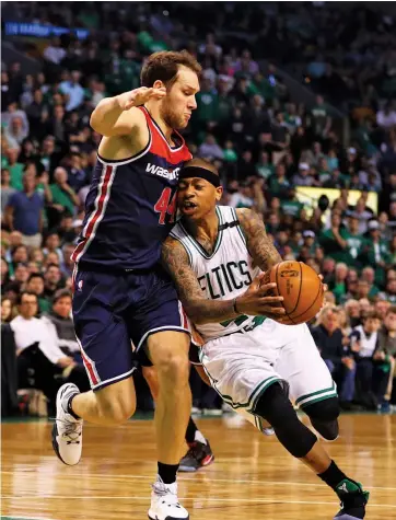  ?? — AFP ?? Isaiah Thomas of Boston Celtics drives against Bojan Bogdanovic of Washington Wizards in their NBA game.