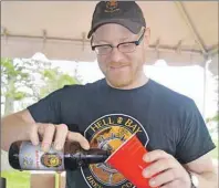  ?? GREG MCNEIL/CAPE BRETON POST ?? Hell Bay Brewing Co. bottled an Irish beer specifical­ly for CanIRONX. Sydney native Mark Bailey is shown pouring a glass.