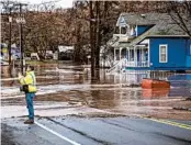  ?? GREG LEHMAN/WALLA WALLA UNION-BULLETIN ?? Water from the Touchet River flows across a highway on Friday on the east side of Waitsburg, Washington.