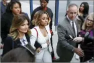  ?? JAE C. HONG — THE ASSOCIATED PRESS ?? Blac Chyna, center, and her attorney Lisa Bloom, left, arrive for a hearing seeking a restrainin­g order against her former fiancee Rob Kardashian on Monday in Los Angeles.
