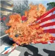  ??  ?? Protesters burn a US flag during angry demonstari­ons in the Philippine­s