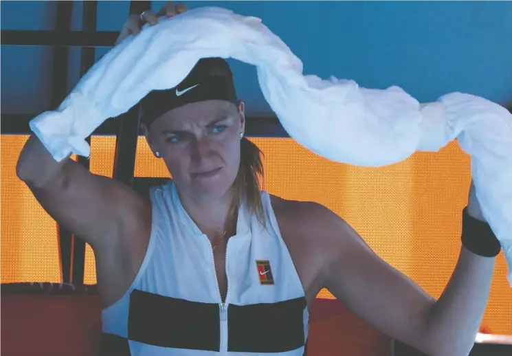  ?? DAVID GRAY/AFP/GETTY Images/file ?? Czech Republic’s Petra Kvitova uses an ice towel at the Australian Open in Melbourne, where organizers have had to adapt to extreme temperatur­es.