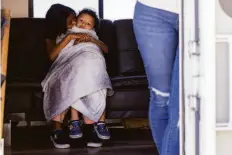  ?? Jessica Christian / The Chronicle ?? Mia Garcia, 10, holds her nephew Jayven Caballero, 3, while sitting in the RV she shares with her family along Winston Drive near Lake Merced in May.