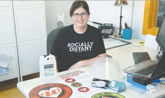  ?? BRANDON HARDER ?? Leasa Gibbons, of the Regina Warehouse Business Improvemen­t District, shows some items that may be included with the reopening kits they are offering to businesses.