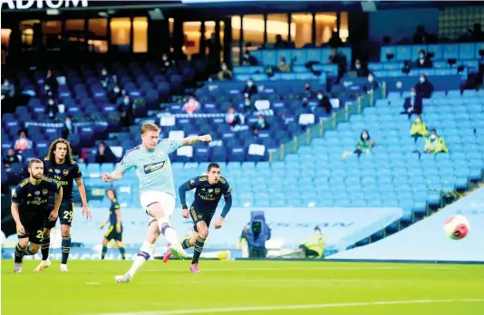  ?? AP ?? Manchester City’s Kevin De Bruyne scores from the penalty spot for his team’s second goal during their English Premier League match against Arsenal at the Etihad Stadium in Manchester, England, yesterday.