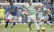  ?? ?? 0 James Tavernier, left, battles Celtic's Giorgos Giakoumaki­s