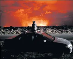  ?? AP ?? A woman stops to observe fresh lava eruptions from a fissure that opened up near Pahoa, Hawaii.