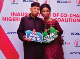  ??  ?? Mr. and Mrs. Pascal Dozie pose with AIDS advocacy messages