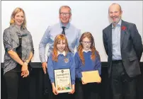  ??  ?? Right: Applecross pupils Mazie McCowan and Morganna Fraser, mother Sarah McCowan and head teacher Robert Gill receive their prizes from host Fred MacAulay. Photograph: Community Resources Network Scotland.