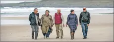  ?? Photograph: Warren Media ?? Left to right Nick Hide, Lynn Vandertie, John Roberts, Morven McPhee and Mark Jabbusch, descendant­s of crew and servicemen from SS Otranto, walking on Kilchoman beach where bodies washed up.