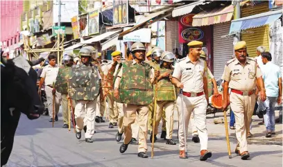  ?? Picture: AFP ?? FULL FORCE. Policemen carry out a flag march through a street in Ajmer yesterday, following the alleged murder of a Hindu tailor by two Muslim men in Udaipur. Western India’s Udaipur city was placed under partial curfew to guard against sectarian violence after a video purporting to show the attempted beheading went viral.