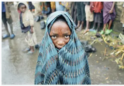  ??  ?? A Congolese child waits in the rain for aid to be distribute­d in Kibati, eastern DR Congo, in this file photo. (AP)