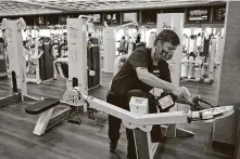  ?? Tony Dejak / Associated Press ?? Jeff Sutter cleans machines at Life Time Beachwood in Ohio. The governor has threatened to close gyms if cases keep rising.