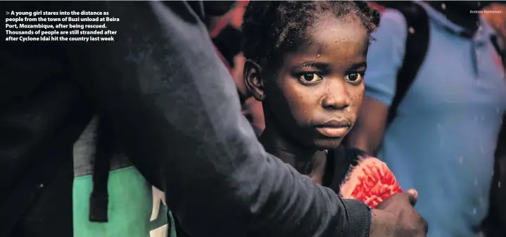  ?? Andrew Renneisen ?? &gt; A young girl stares into the distance as people from the town of Buzi unload at Beira Port, Mozambique, after being rescued. Thousands of people are still stranded after after Cyclone Idai hit the country last week