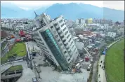  ?? AP ?? A residentia­l building leans on its collapsed first floor after a powerful earthquake early on Wednesday in Hualien, Taiwan. Rescue crews continue to try to free people from damaged buildings. At least seven people were killed and hundreds injured.