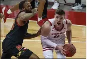  ?? MORRY GASH — THE ASSOCIATED PRESS ?? Wisconsin’s Micah Potter tries to get past Maryland’s Galin Smith on Monday in Madison, Wis.