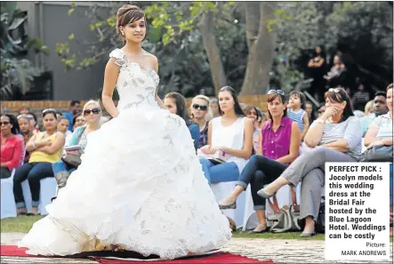  ?? Picture: MARK ANDREWS ?? PERFECT PICK : Jocelyn models this wedding dress at the Bridal Fair hosted by the Blue Lagoon Hotel. Weddings can be costly