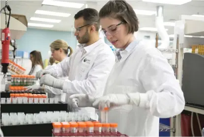  ?? PROVIDED ?? A technician labels tubes at Exact Sciences Laboratori­es. With two dozen steps to the testing procedure over a period of days, making sure patient informatio­n stays with every sample is a priority.