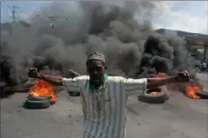  ?? Clarens Siffroy/AFP via Getty Images ?? A protester reacts while tires burn in the street Tuesday during a demonstrat­ion following the resignatio­n of Prime Minister Ariel Henry in Port-au-Prince, Haiti.