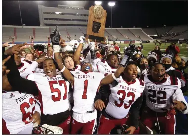  ?? (Arkansas Democrat-Gazette/Thomas Metthe) ?? Fordyce players celebrate with the trophy after defeating Des Arc on Saturday night in the Class 2A championsh­ip game at War Memorial Stadium in Little Rock. It was the Redbugs’ second consecutiv­e state title. More photos available at arkansason­line. com/1213fordar­c.