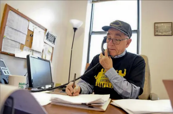  ?? Alexandra Wimley/Post-Gazette ?? Barney Oursler talks to a potential client facing unemployme­nt in his Mon Valley Unemployed Committee office on the North Side.