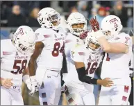  ?? Stephen Dunn / Associated Press ?? Temple quarterbac­k Todd Centeio (16) is congratula­ted after scoring in the first half against UConn on Saturday.