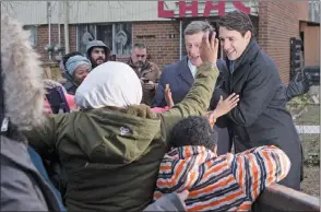  ?? CP PHOTO ?? Canadian Prime Minister Justin Trudeau (right) and Toronto Mayor John Tory greets residents after visitng a housing developmen­t in Toronto’s Lawrence Heights neighbourh­ood to make a policy announceme­nt, on Wednesday.