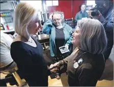  ?? Charlie Neibergall Associated Press ?? SEN. KIRSTEN GILLIBRAND, at left campaignin­g in Iowa, says the Russia investigat­ion is “not at the top of mind of most voters.”