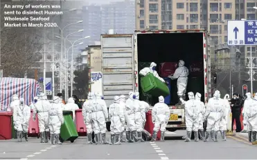  ??  ?? An army of workers was sent to disinfect Huanan Wholesale Seafood Market in March 2020.