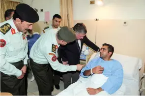  ?? Jordan’s Royal Palace/Handout via Reuters ?? JUSTICE SERVED: Jordan’s King Abdullah, second right, visits a man in hospital who was wounded in a shooting at a U.S.-funded police training facility, in Amman, in this November 9, 2016 handout picture. Photo -